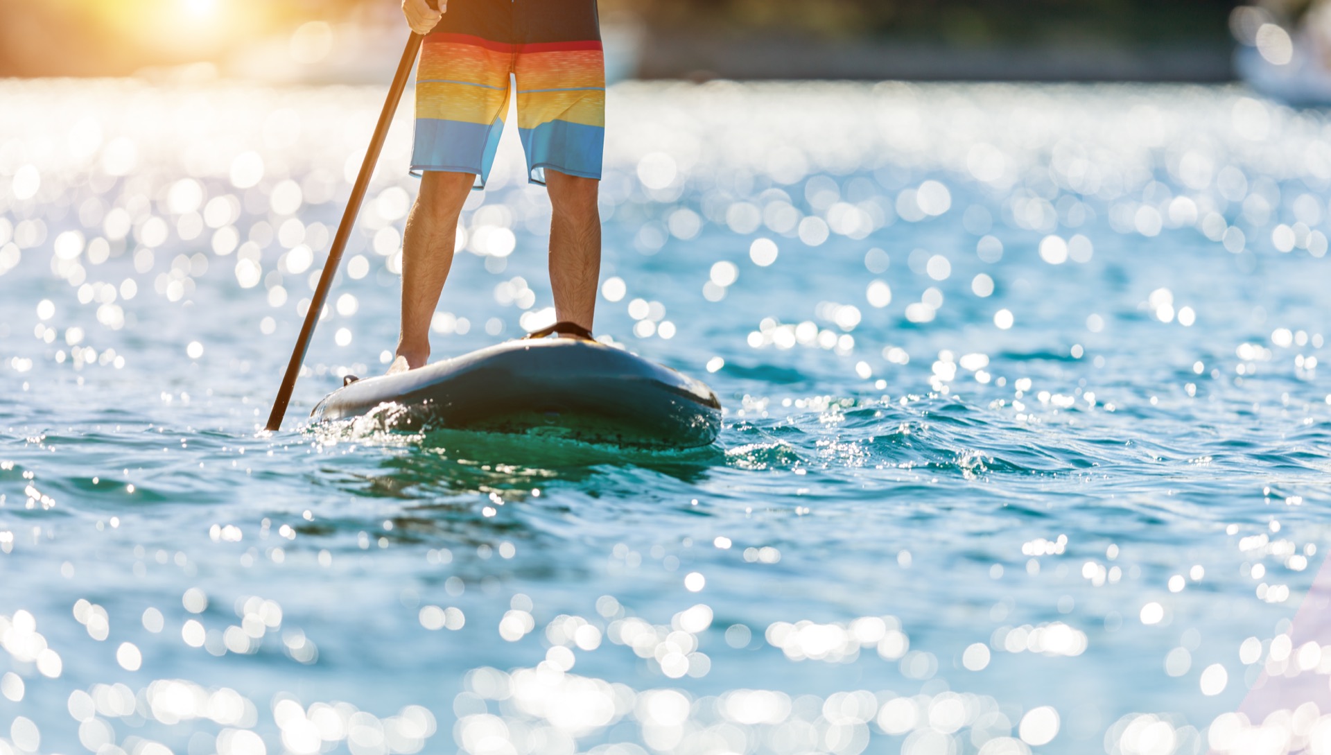 Young guy on paddleboard on Okanagan Lake