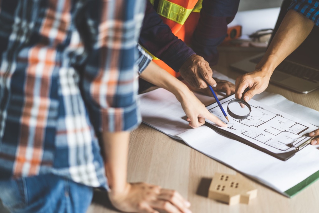 Contractors reviewing pre-construction home floorplan